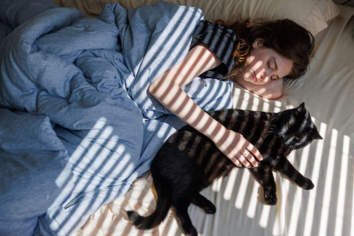 The real reason your cat loves to sleep by your side